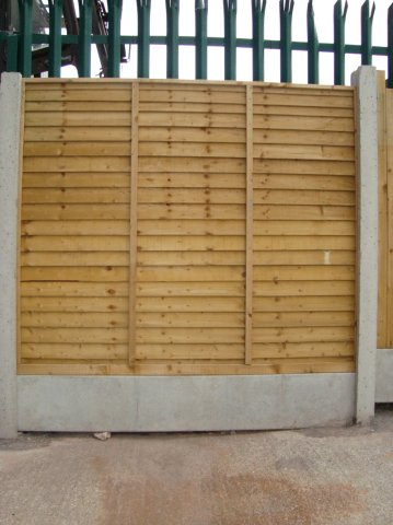 Pressure Treated Overlap Panels in Concrete Posts and with Gravel Board